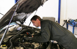 a mechanic fixing a diesel engine
